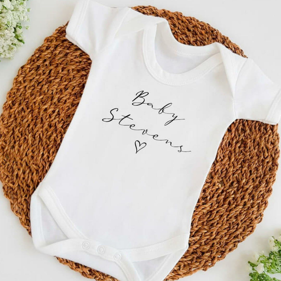 Baby announcement vests that says: Baby Stevens with a heart underneath
