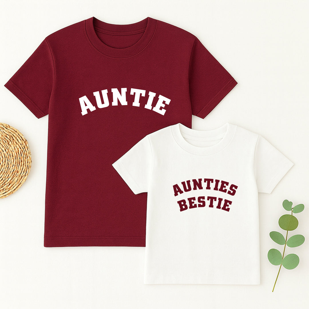 Two t-shirts, one red with 'AUNTIE' and one white with 'AUNTIES BESTIE', on a white background.