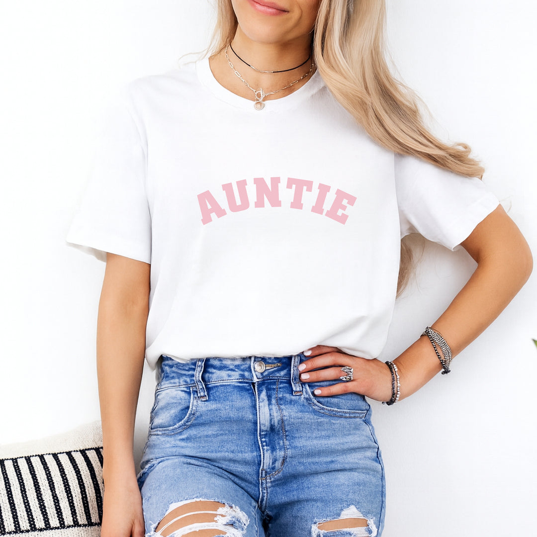 Person wearing a white t-shirt with 'AUNTIE' printed in pink on a white background