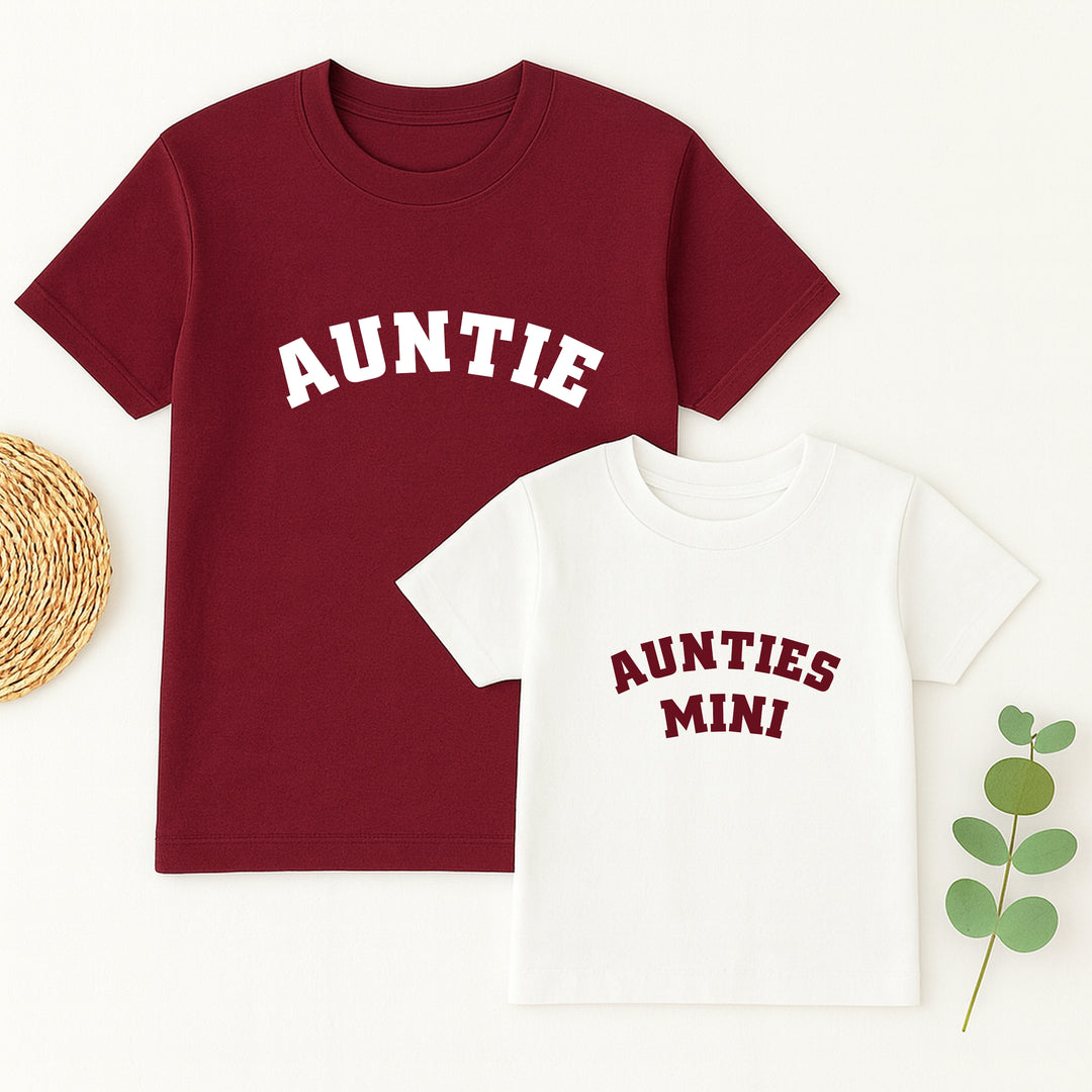 Two t-shirts, one red with 'Auntie' and one white with 'Aunties Mini', on a white background.