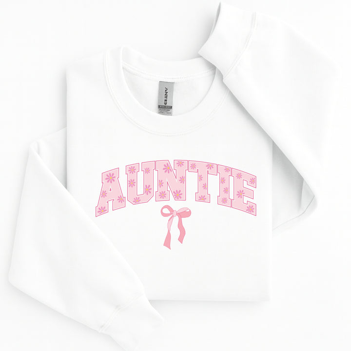 White hoodie with 'AUNTIE' in pink text and a bow on a white background