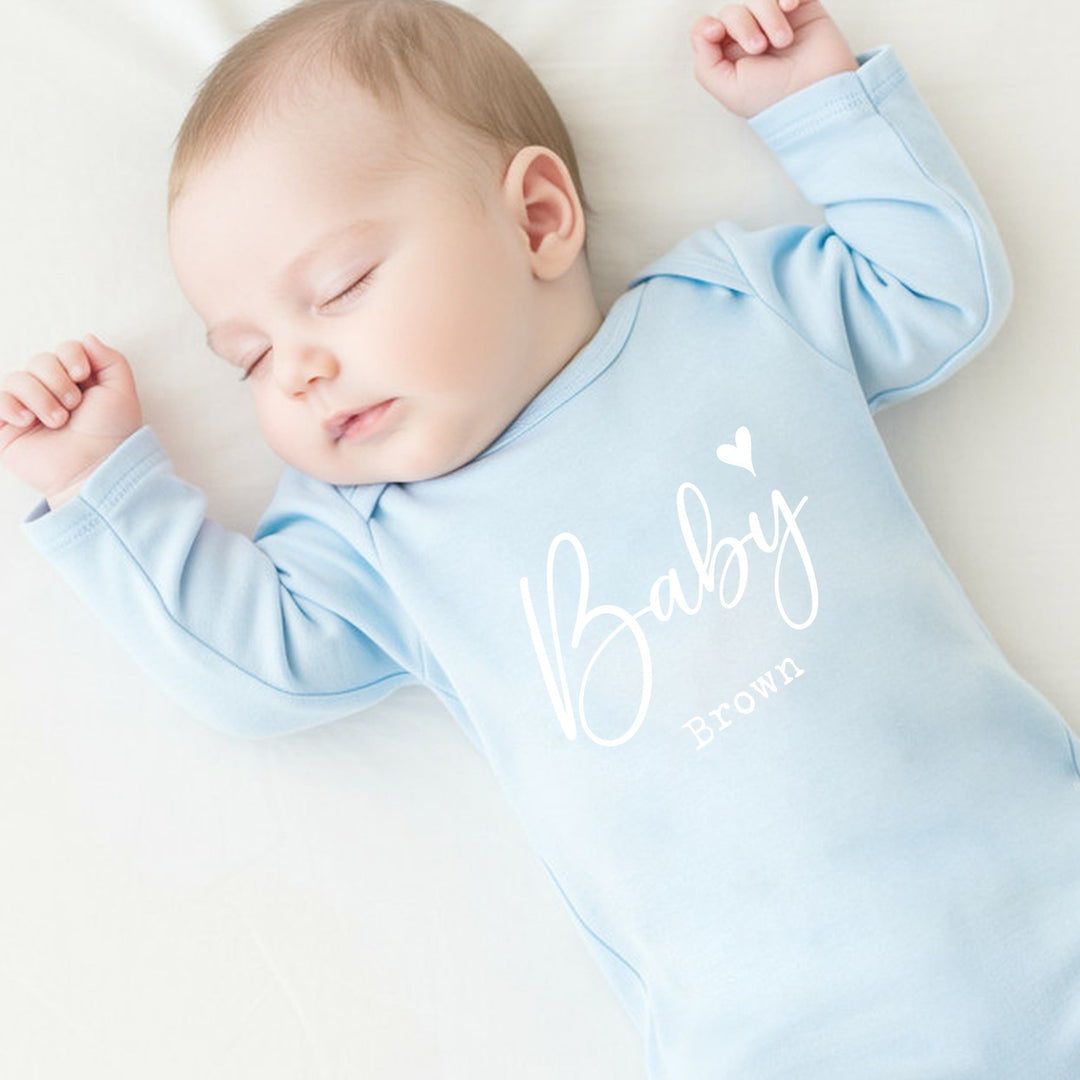 a personalised blue baby grow that says 'Baby Brown'