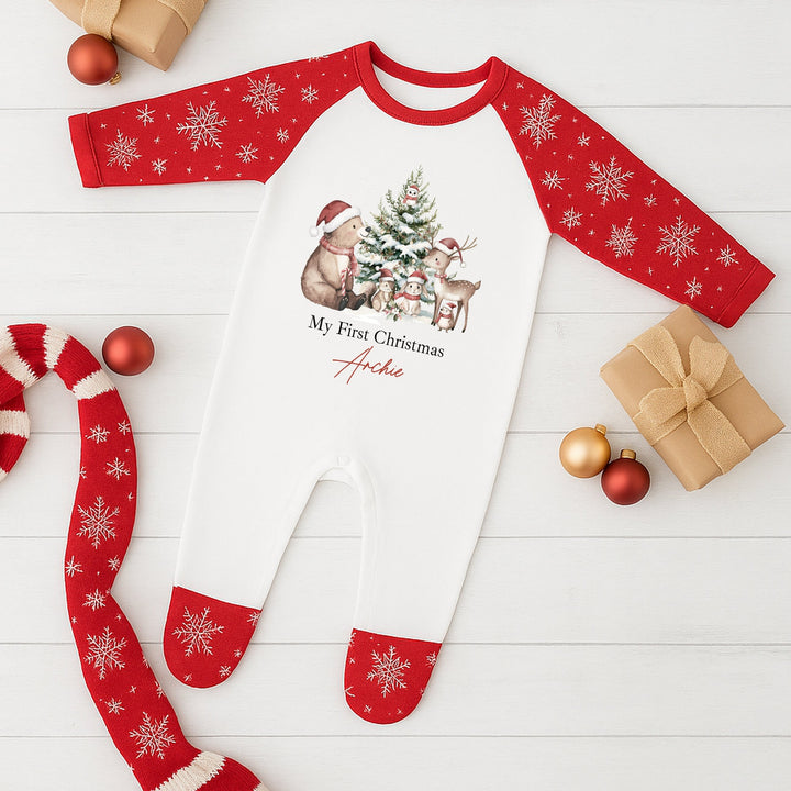 Red and white Christmas-themed long-sleeve shirt with snowflakes on a wooden surface.