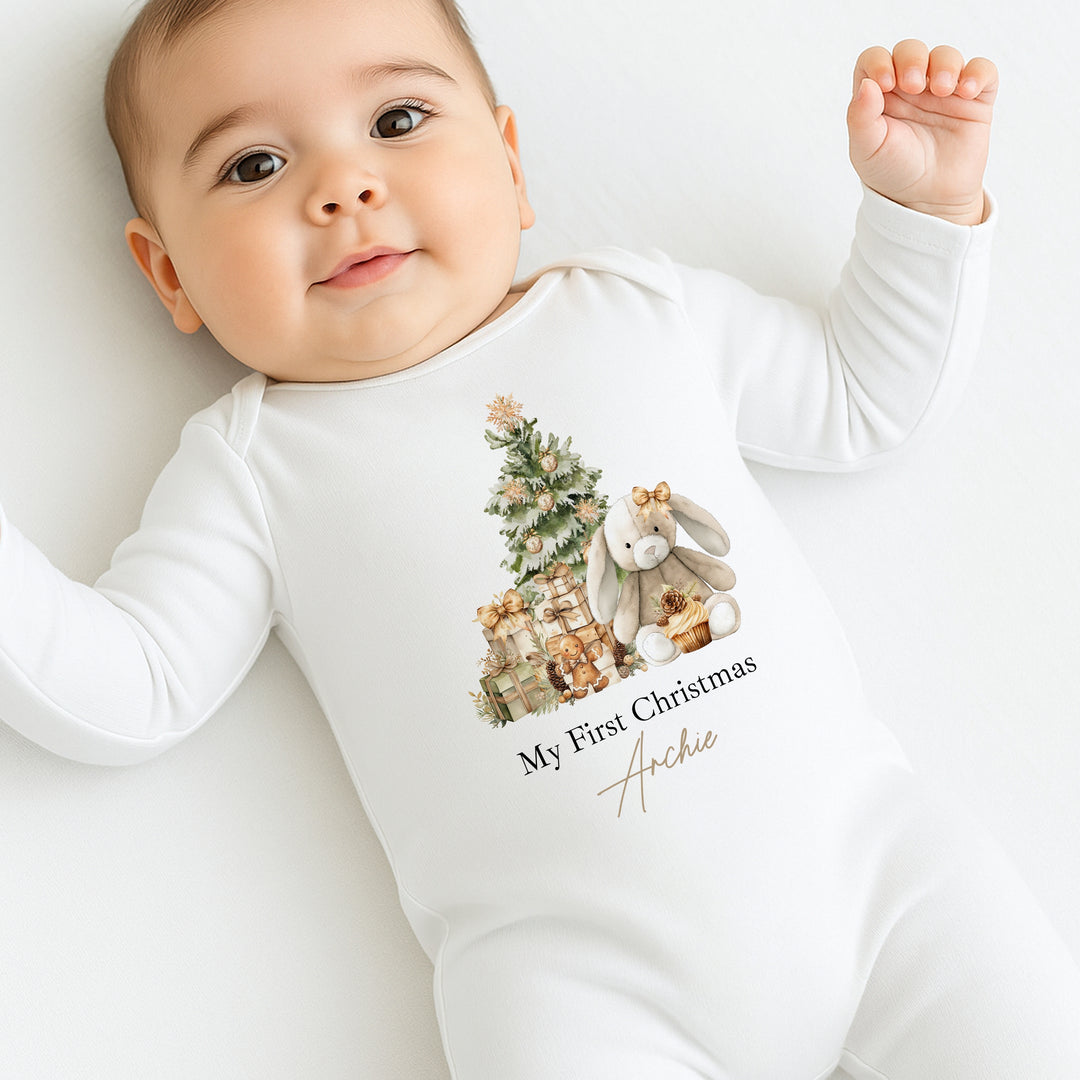 Baby wearing a white onesie with a Christmas design and text on a white background
