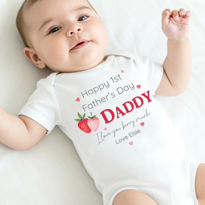 Personalised white Father's Day baby vest that says 'Happy 1st Father's Day Daddy I love you berry much Love Elsie'. This design features 2 strawberries and pink hearts