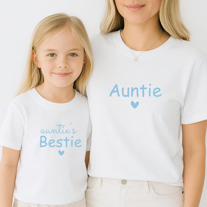 Woman and child wearing matching white t-shirts with blue text on a plain background