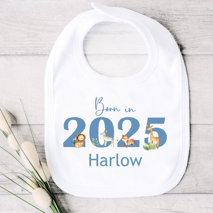 a personalised white baby bib that says 'Born in 20245 Harlow'. This design features safari animals