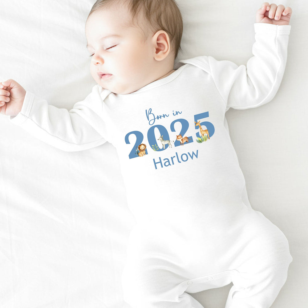 a personalised white baby grow that says 'Born in 20245 Harlow'. This design features safari animals