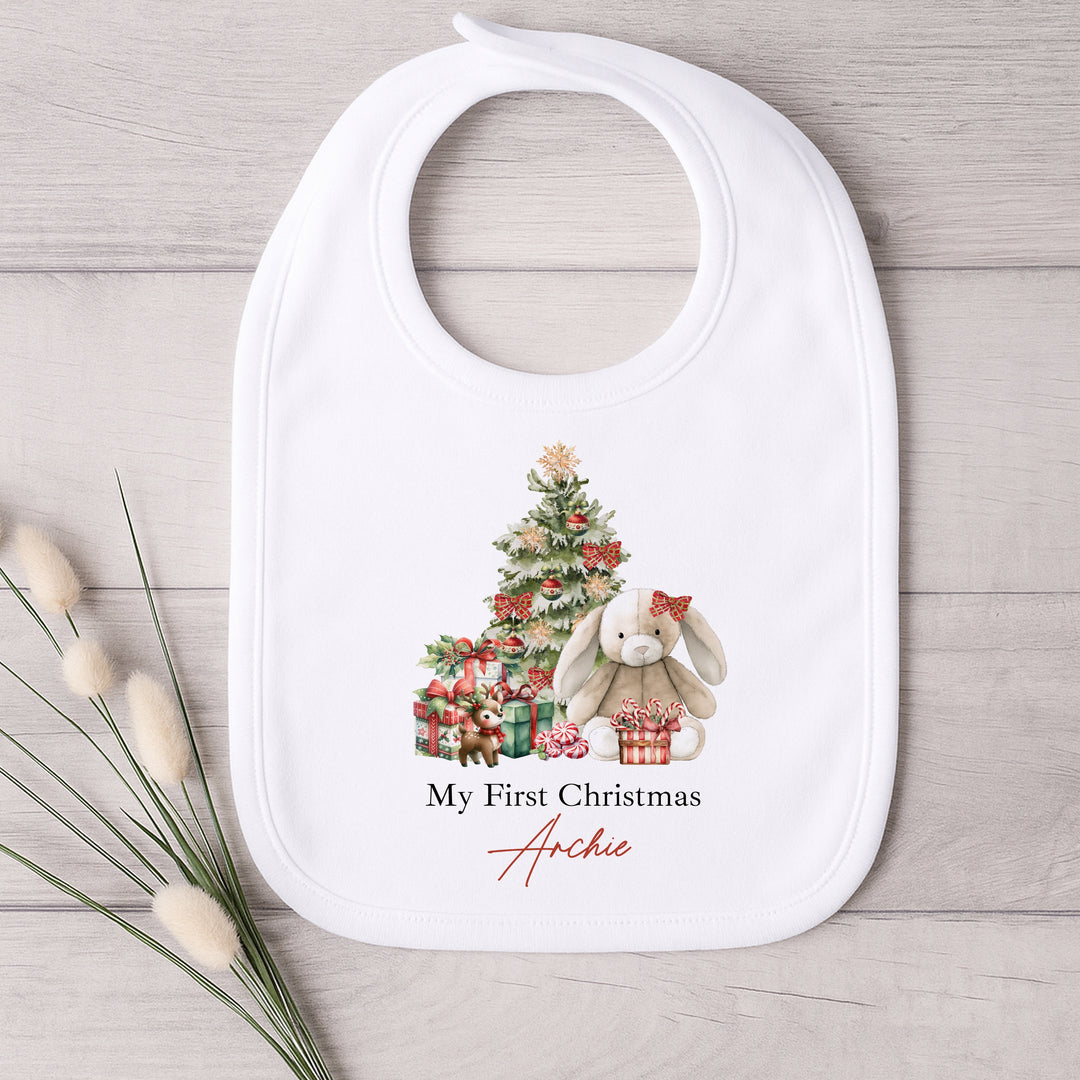 Baby bib with Christmas design and text on a wooden surface