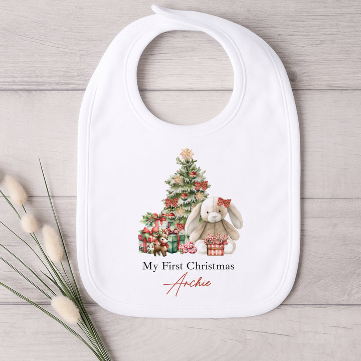 Baby bib with Christmas design and text on a wooden surface