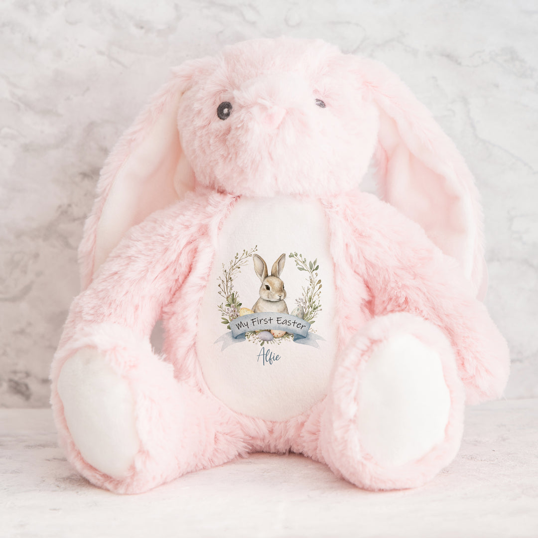 Personalised pink bunny Easter teddy that says 'My First Easter Alfie'. This design features a grey bunny in a wreath
