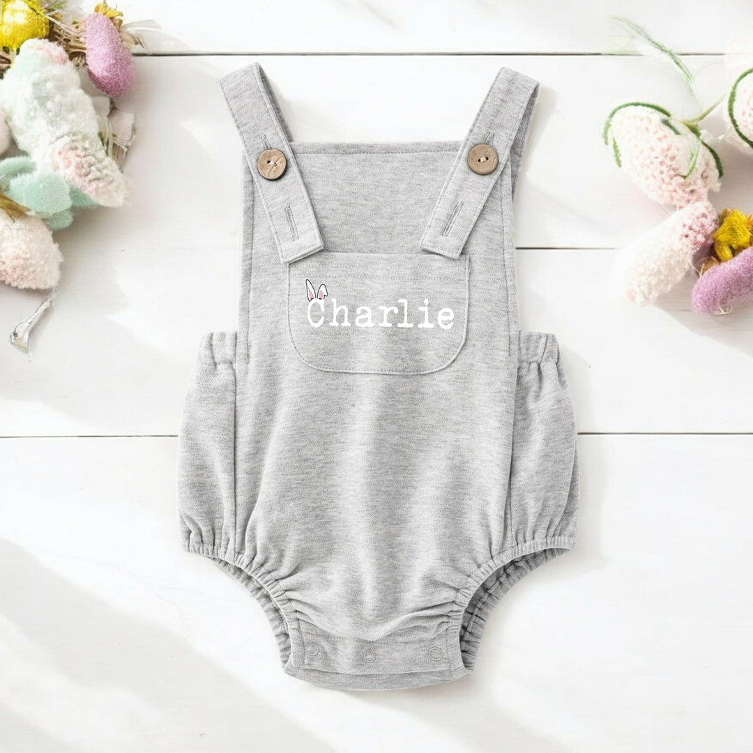Persoanlised grey Easter dungarees that say 'Charlie'.