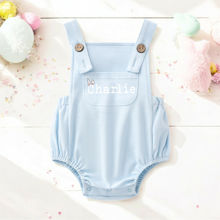 Persoanlised blue Easter dungarees that say 'Charlie'.