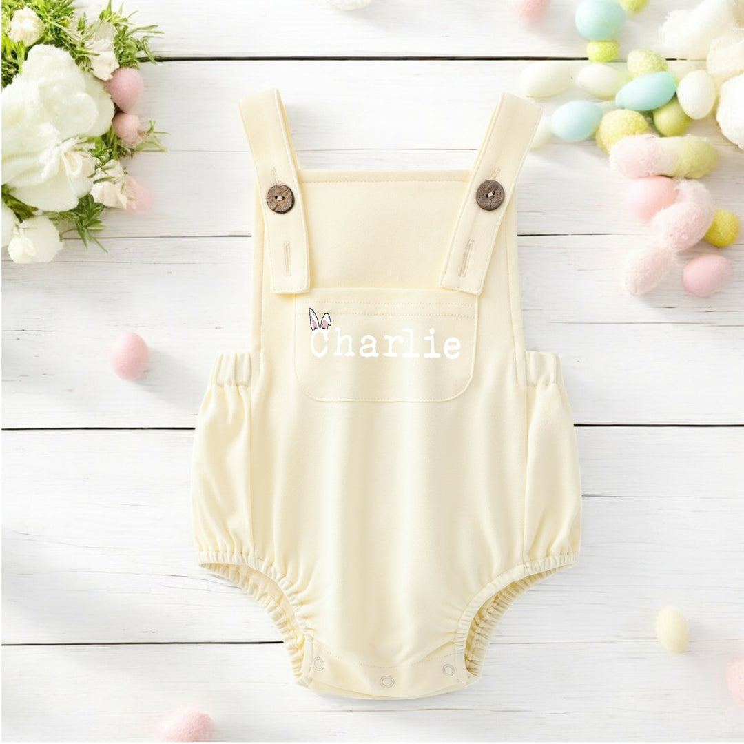 Persoanlised lemon yellow Easter dungarees that say 'Charlie'.