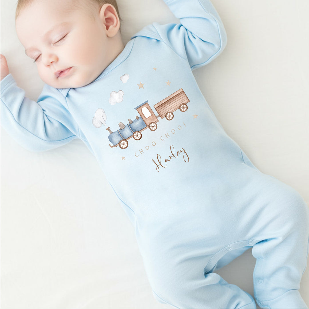 a personalised blue baby grow that says 'Choo Choo! Harley'. This design features a blue steam train