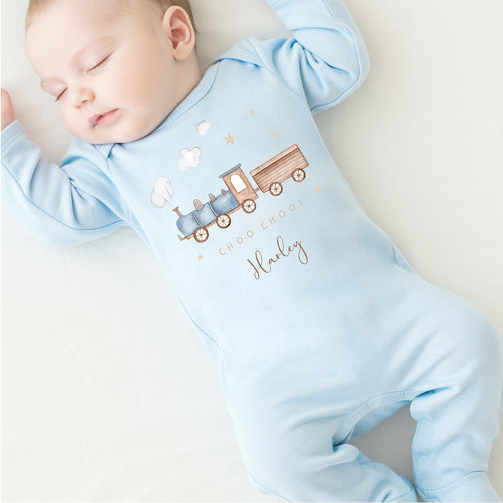 a personalised blue baby grow that says 'Choo Choo! Harley'. This design features a blue steam train