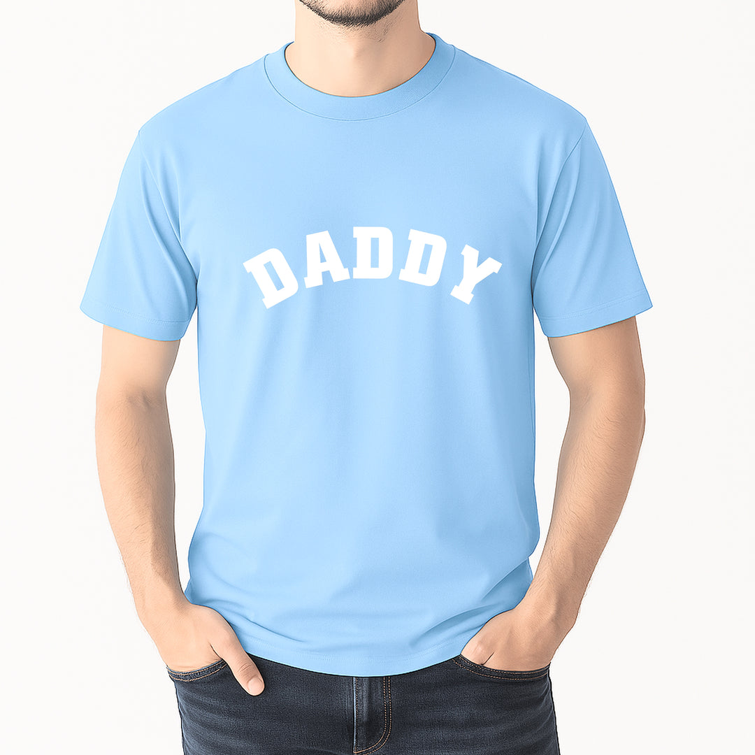 Light blue t-shirt with 'DADDY' text worn by a person on a white background