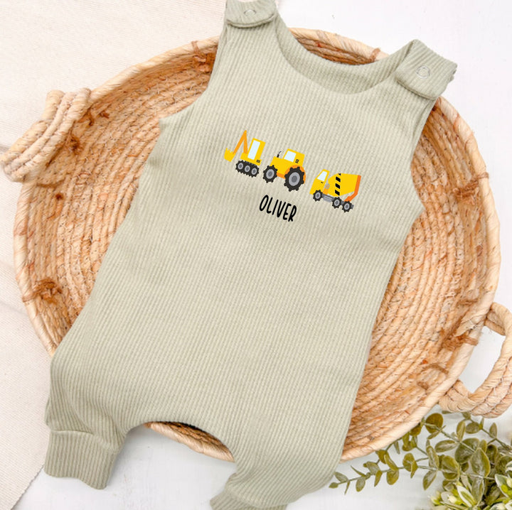 Personalised sage green ribbed dungarees that say 'Oliver'. This design features 3 diggers