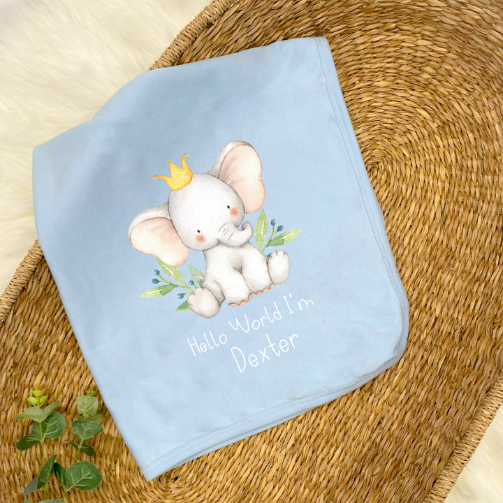 a personalised blue baby blanket that says 'Hello World I'm Dexter'. This design features an elephant wearing a crown