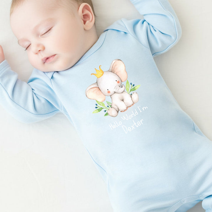 a personalised blue baby grow that says 'Hello World I'm Dexter'. This design features an elephant wearing a crown