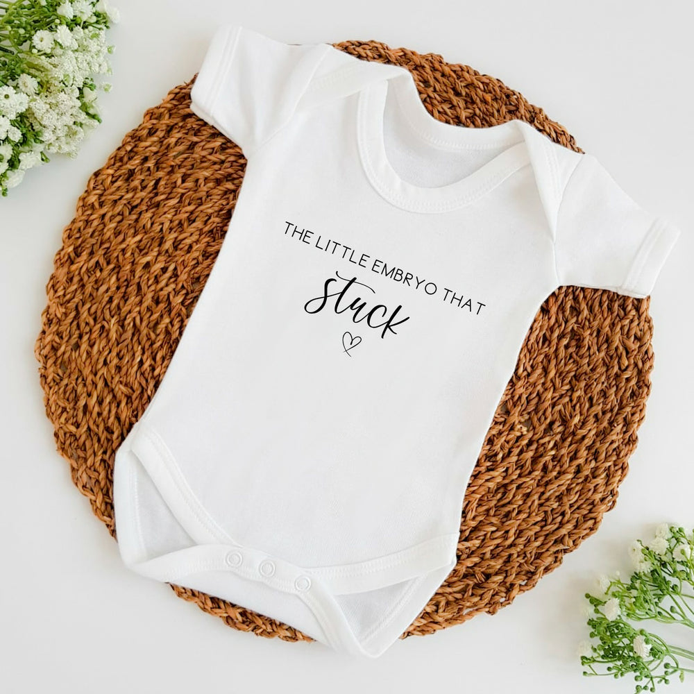 Baby announcement vests that says: The little embryo that stuck with a heart under