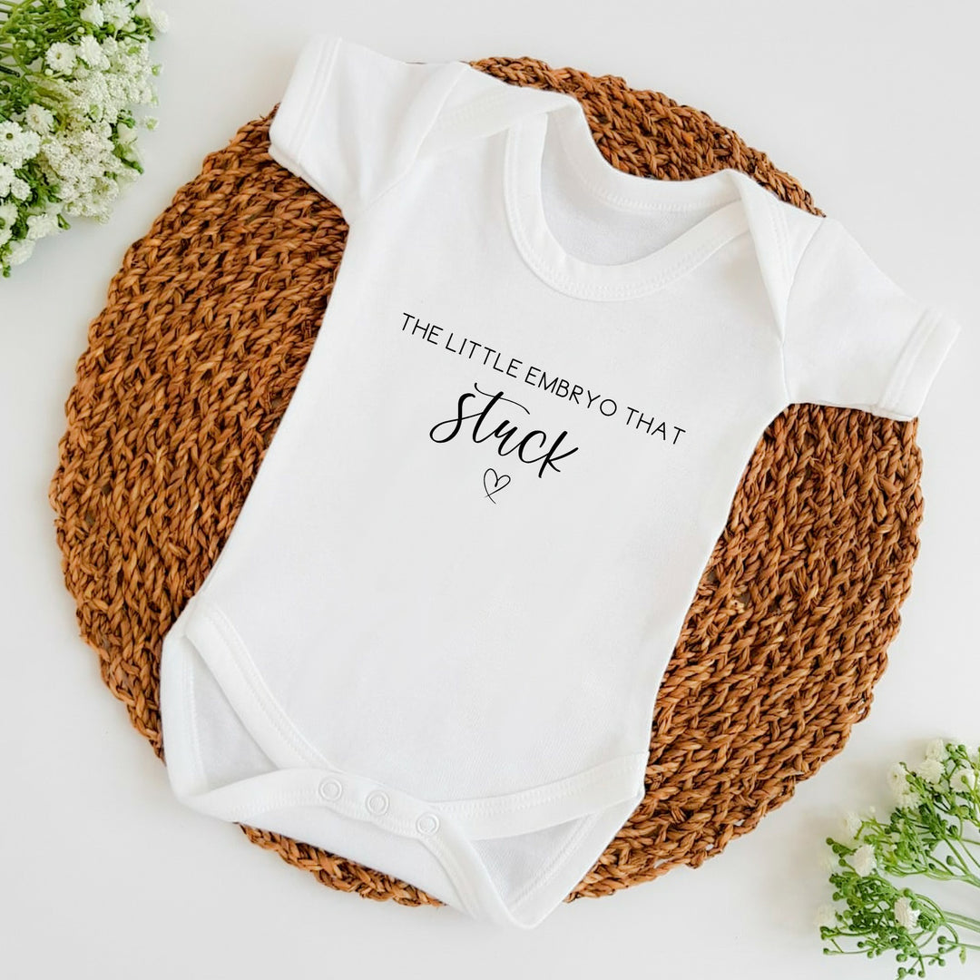 Baby announcement vests that says: The little embryo that stuck with a heart under