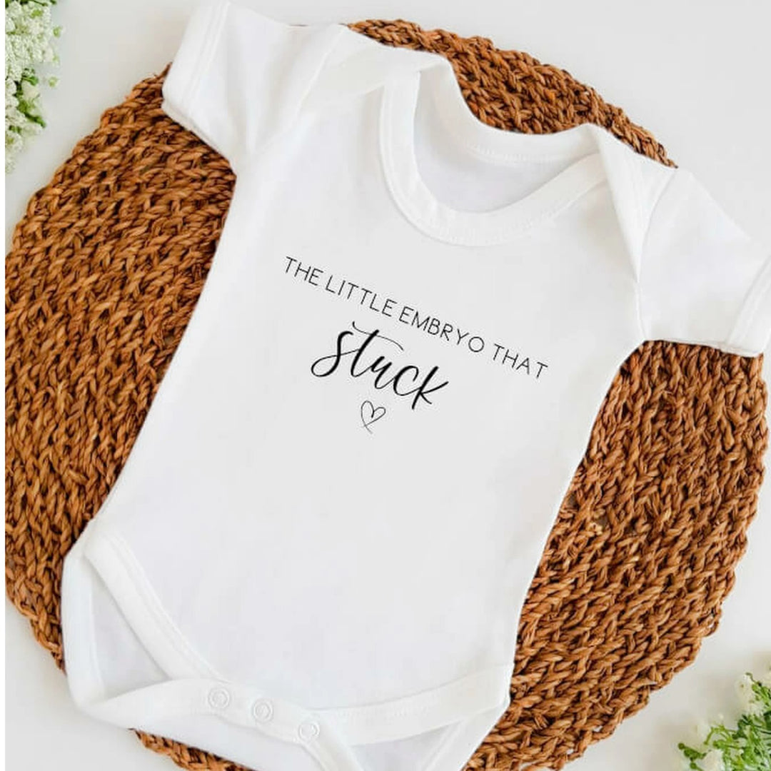 Baby announcement vests that says: 
The little embryo that stuck with a heart underneath