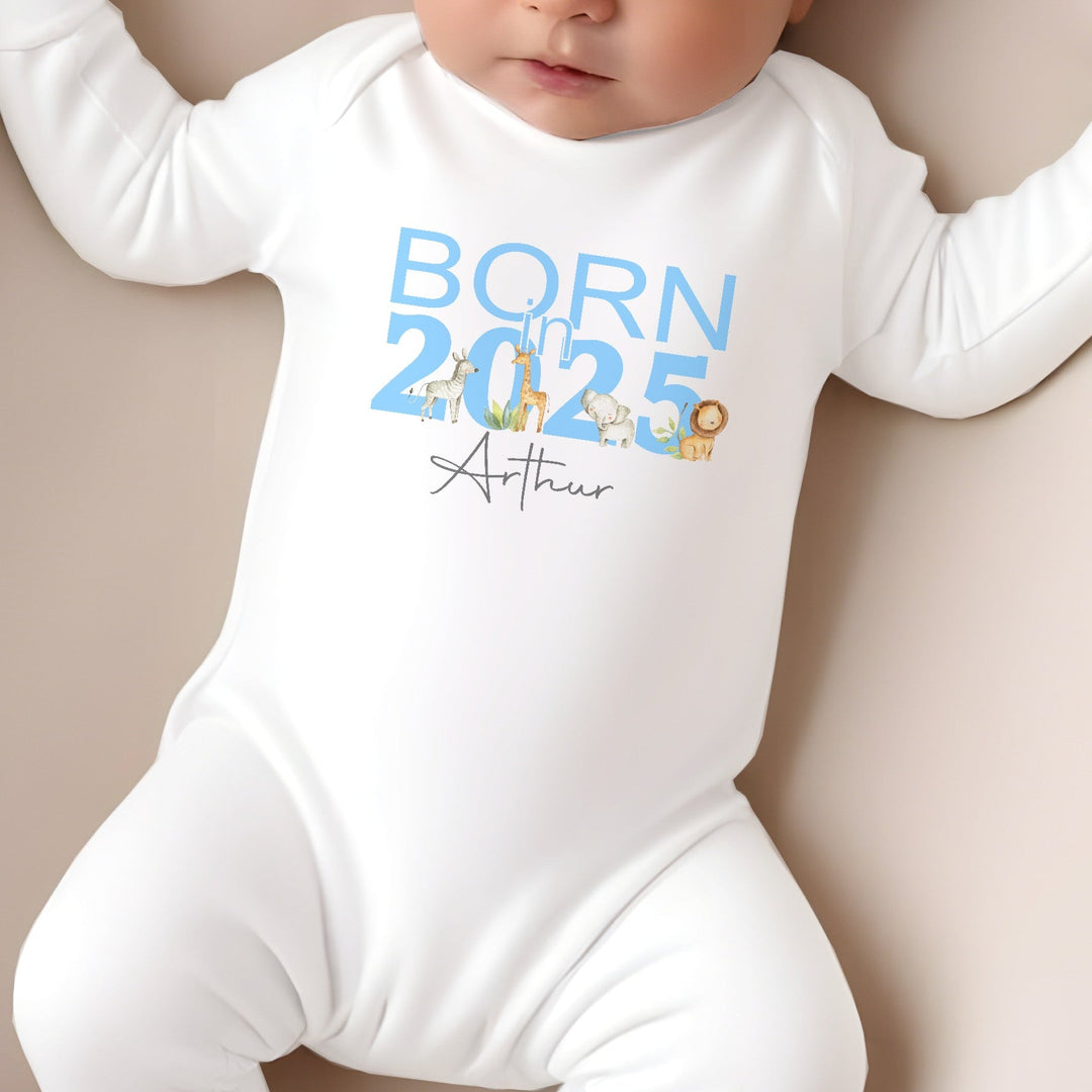 a personalised white baby grow that says 'Born in 2025 Arthur'. This design features safari animals