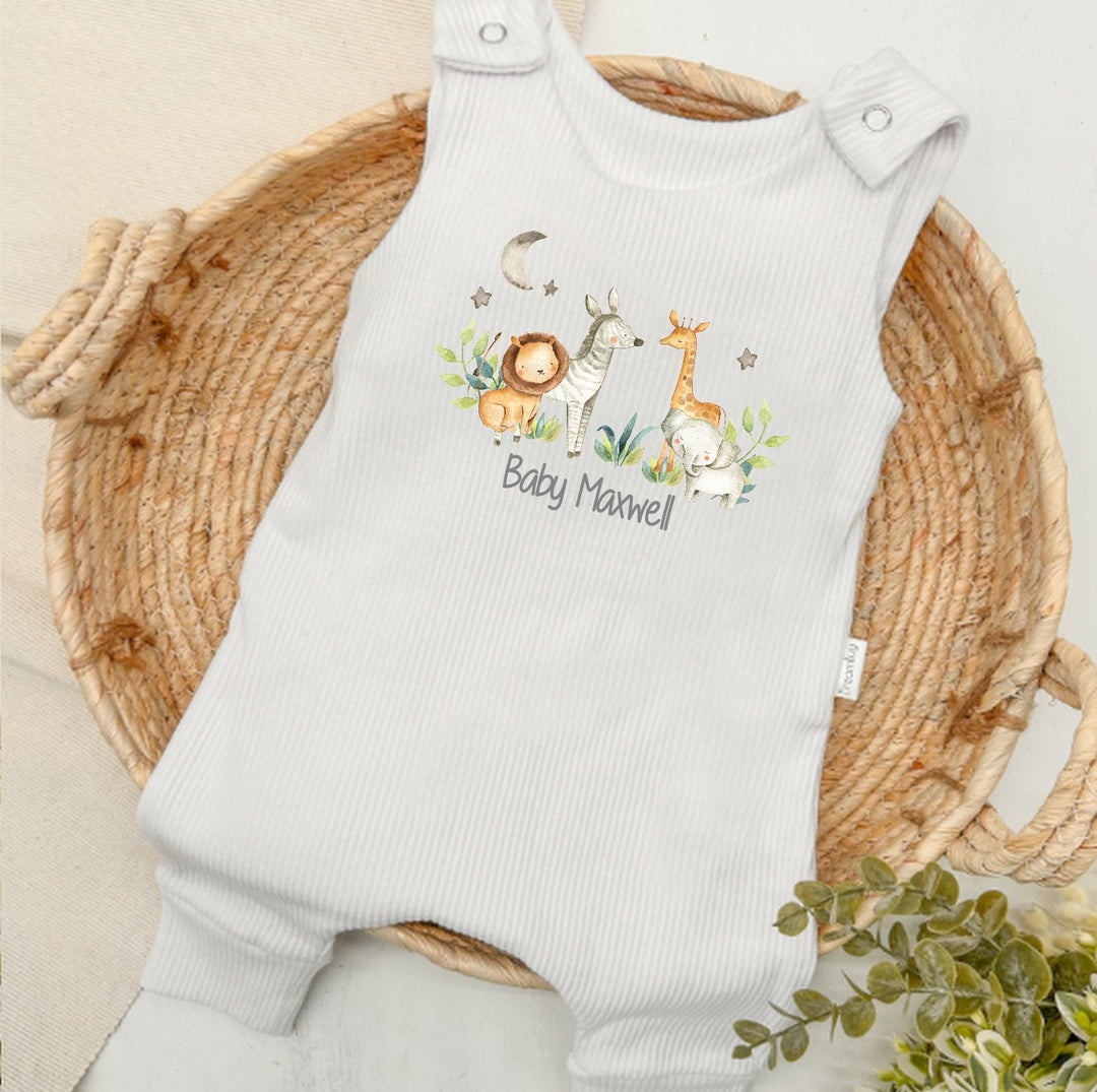 Personalised white ribbed dungarees that say 'Baby Maxwell'. This design features a jungle scene