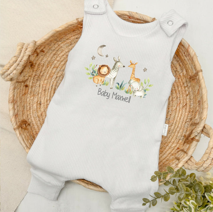 Personalised white ribbed dungarees that say 'Baby Maxwell'. This design features a jungle scene