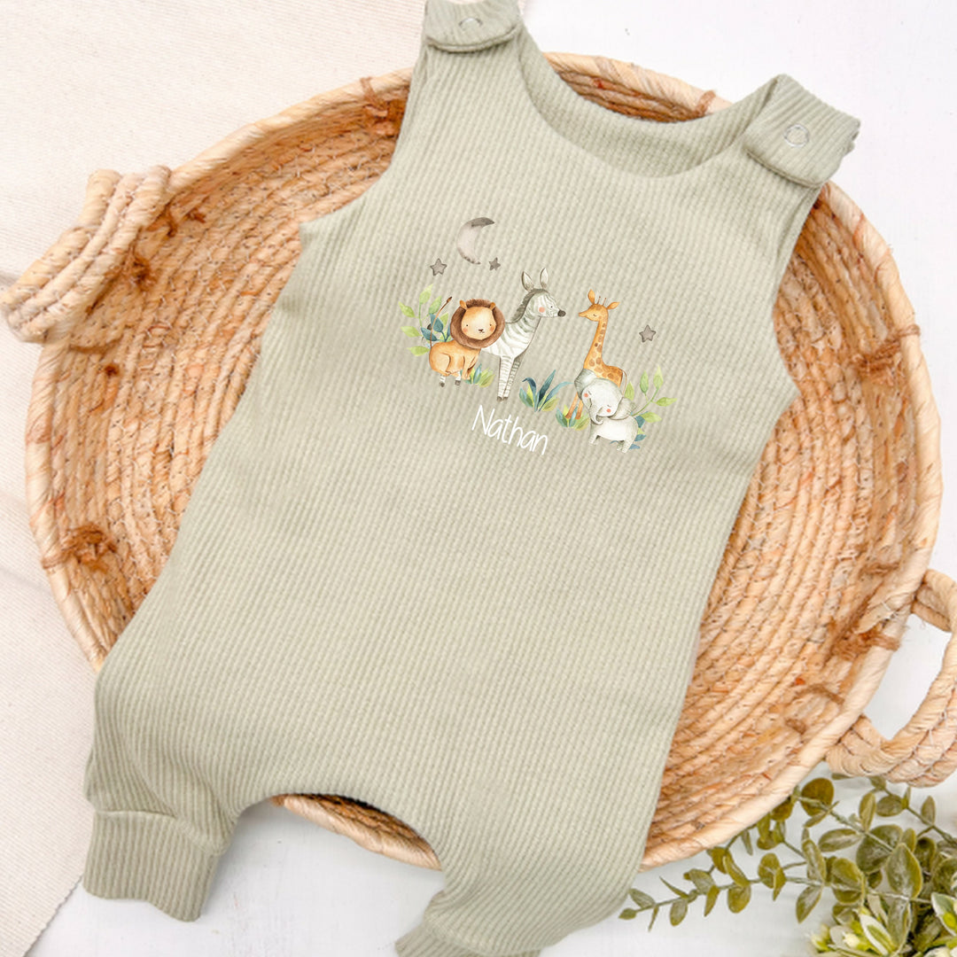 Personalised sage green ribbed dungarees that say 'Nathan'. This design features a jungle scene