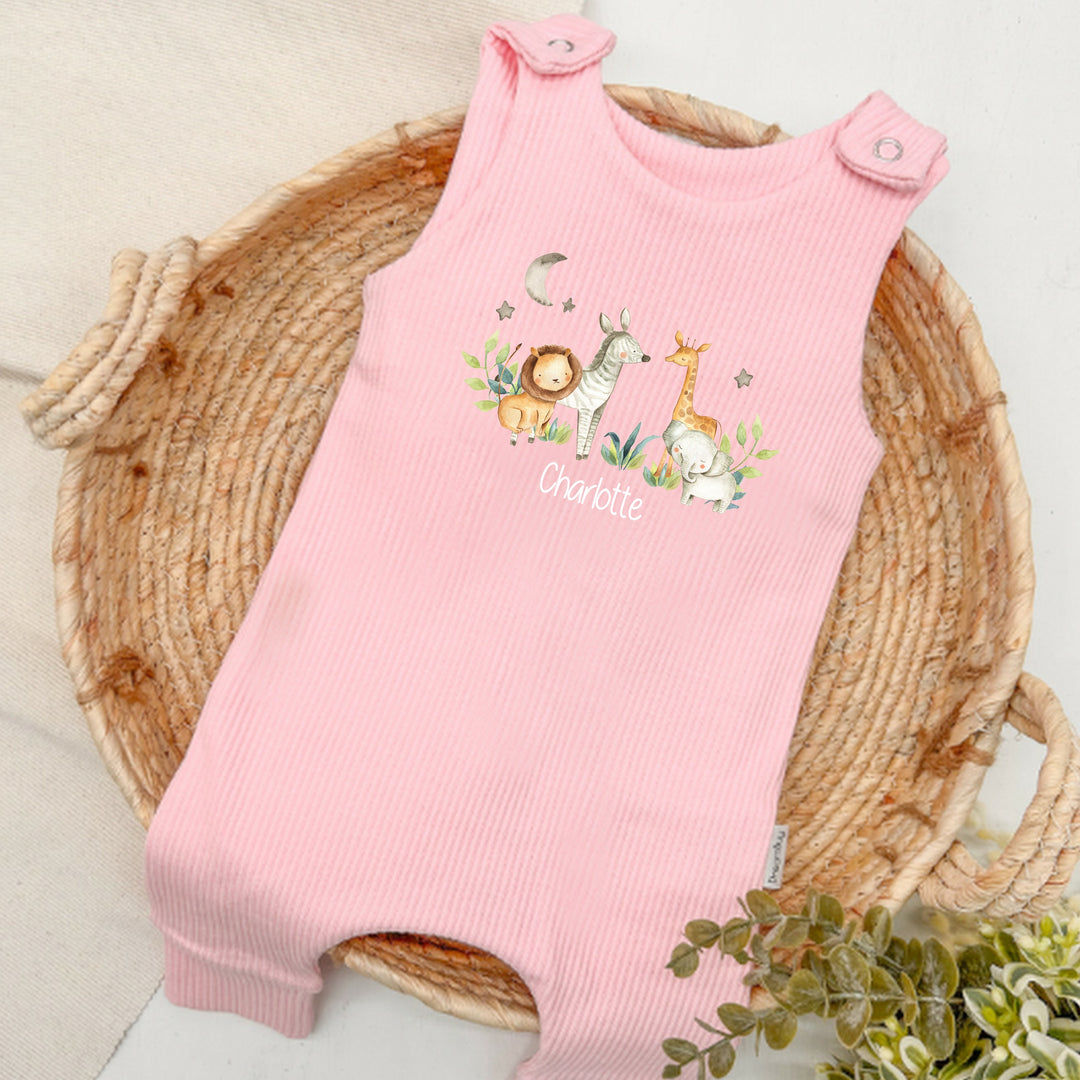 Personalised pink ribbed dungarees that say 'Charlotte'. This design features a jungle scene