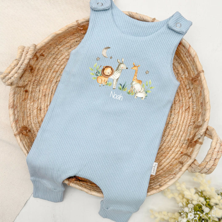 Personalised blue ribbed dungarees that say 'Noahl'. This design features a jungle scene