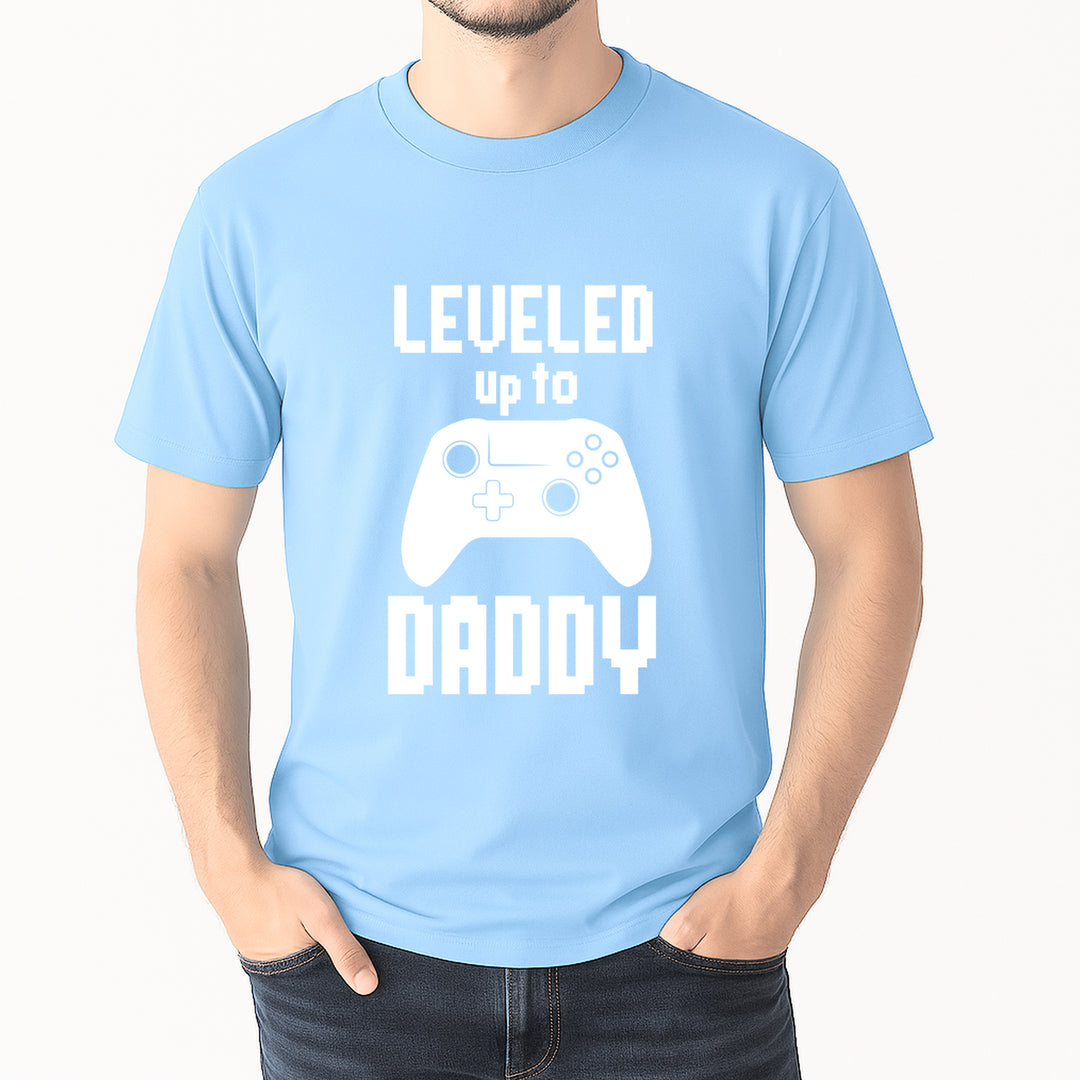 Light blue t-shirt with 'Leveled up to Daddy' text and gaming controller graphic on a white background