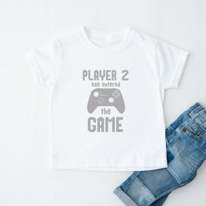 White t-shirt with 'Player 2 has entered the game' text and a controller graphic, paired with blue jeans on a white background.