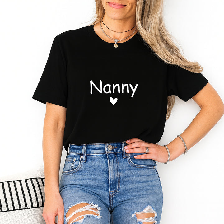 Person wearing a black t-shirt with 'Nanny' printed on it, standing against a white background.