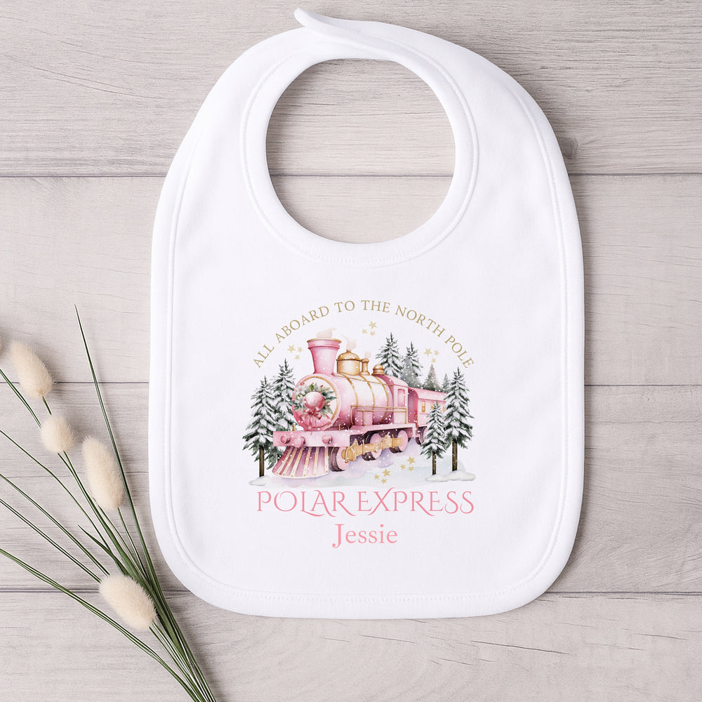 Baby bib with Polar Express design on a wooden surface