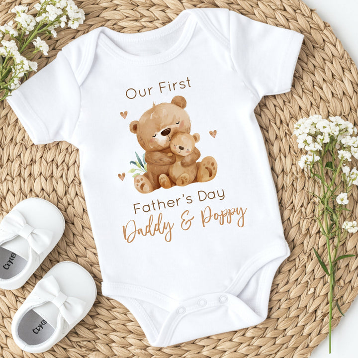 Personalised white Father's Day baby vest that says 'Our First Father's Day Daddy & Poppy'. This design features 2 brown bears
