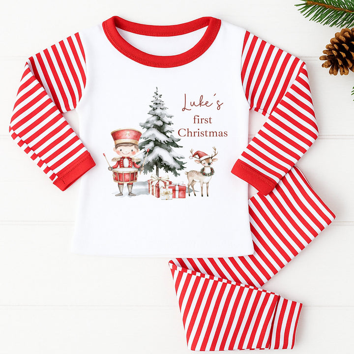 Red and white striped children's pajama set with Christmas-themed design on a white background.