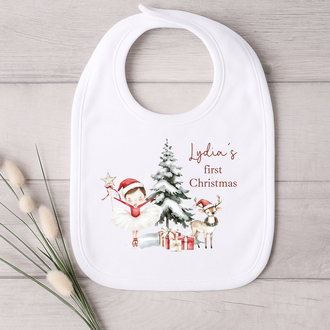 Baby bib with Christmas design and text on a wooden surface