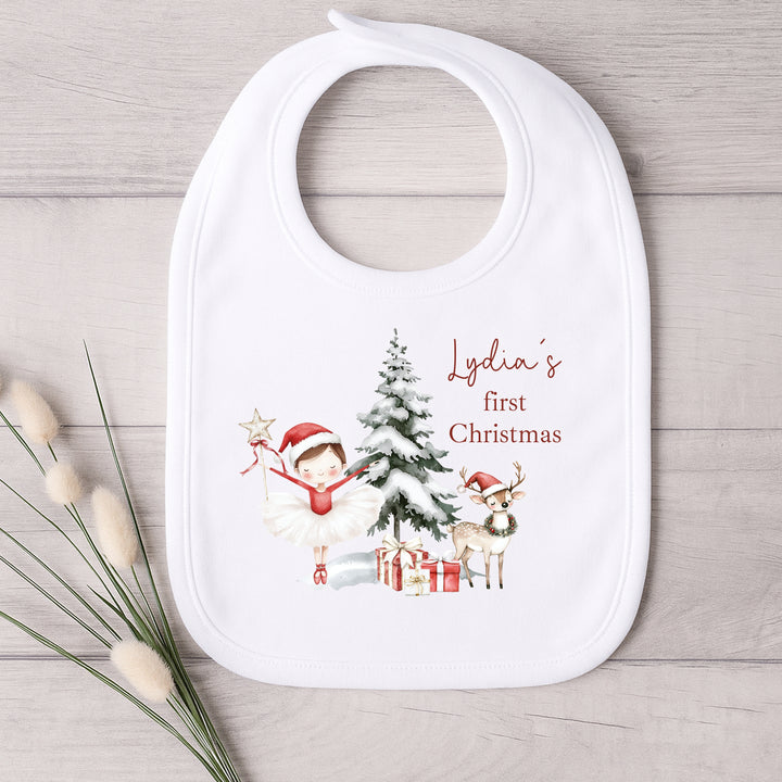 Baby bib with Christmas design and text on a wooden surface