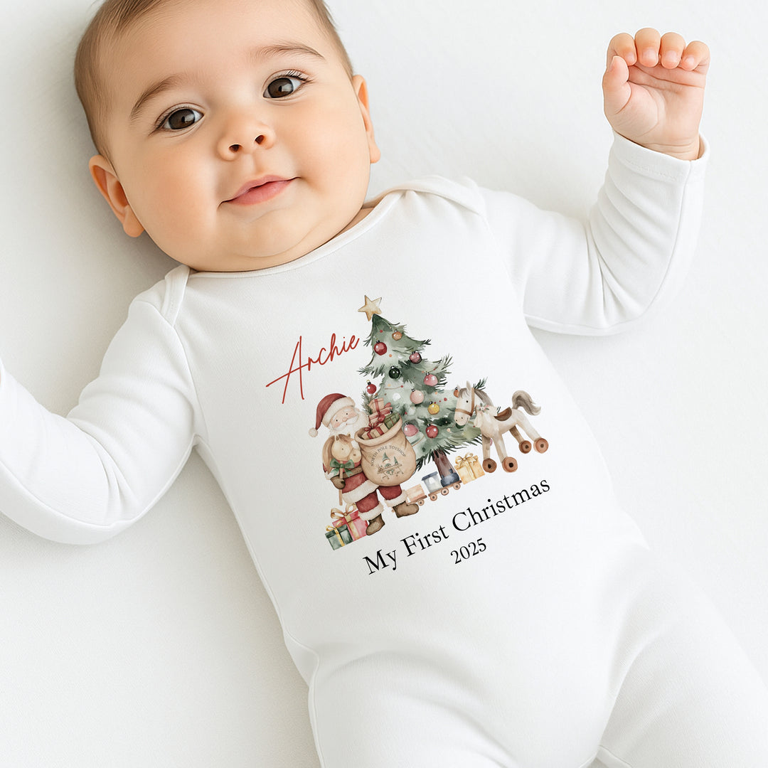 Baby wearing a white onesie with Christmas-themed design and text on a light background