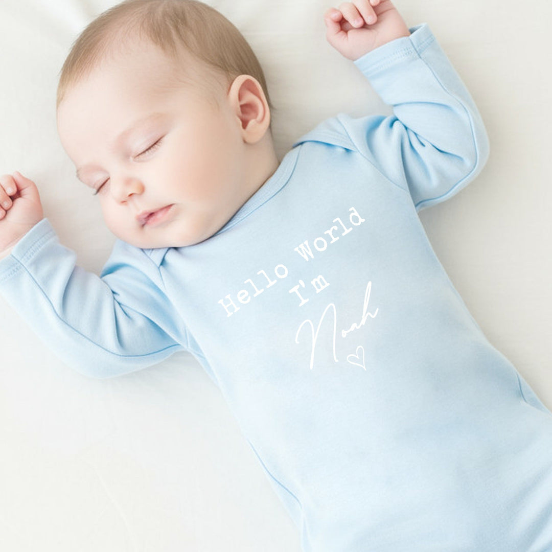 a personalised blue baby grow that says 'Hello World I'm Noah'