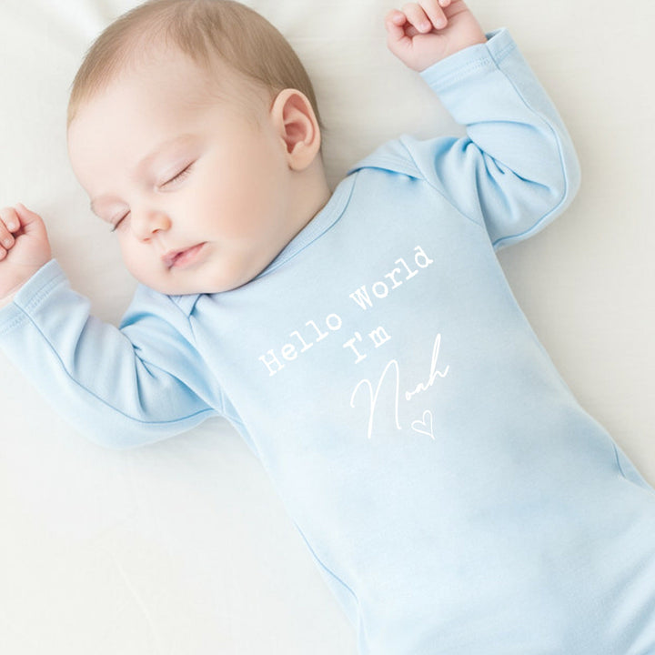 a personalised blue baby grow that says 'Hello World I'm Noah'