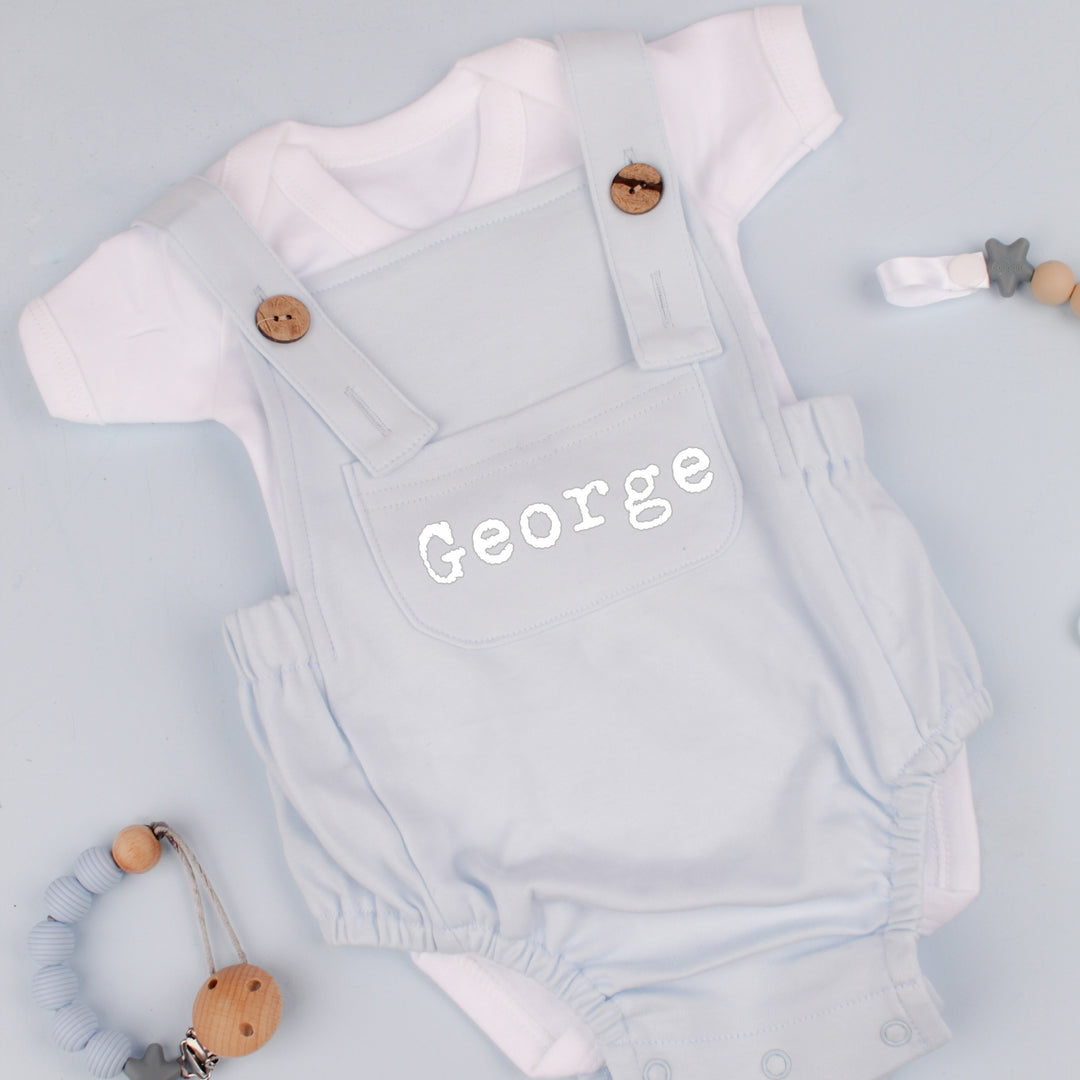 a personalised blue dungarees that say 'George'