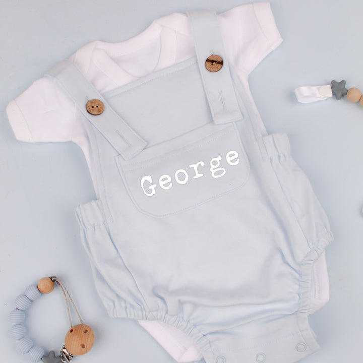 a personalised blue dungarees that say 'George'