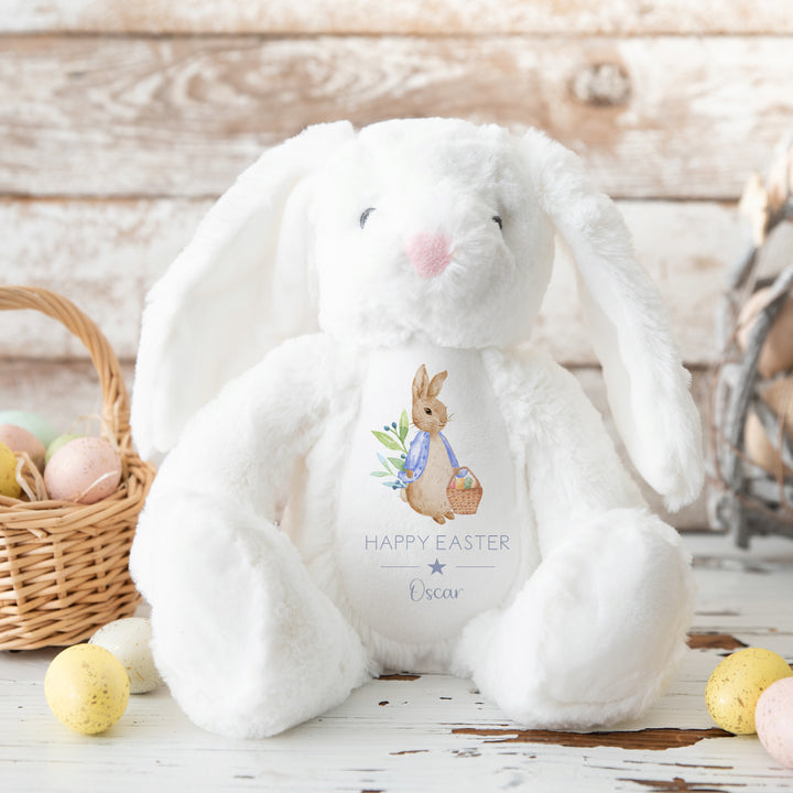 Personalised white bunny Easter teddy that says 'Happy Easter Oscar'. This design features a rabbit wearing a blue jacket holding an Easter basket