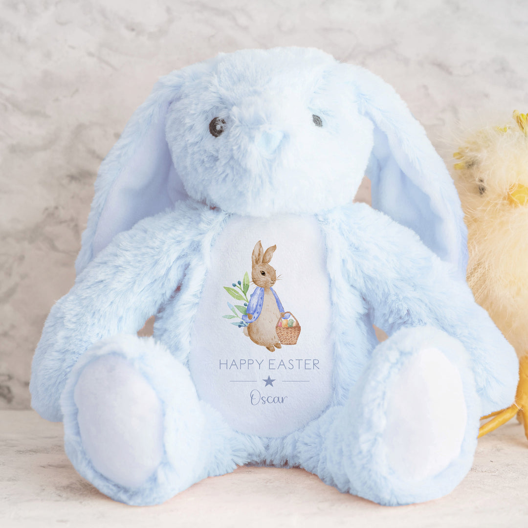 Personalised blue bunny Easter teddy that says 'Happy Easter Oscar'. This design features a rabbit wearing a blue jacket holding an Easter basket