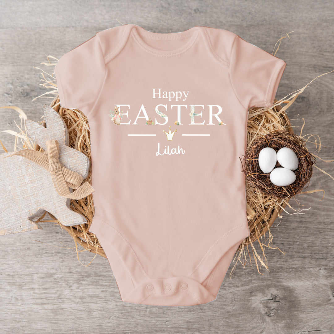 Personalised pink Easter baby vest that says 'Happy Easter Lilah'. This design features a rabbit wearing a pink jacket