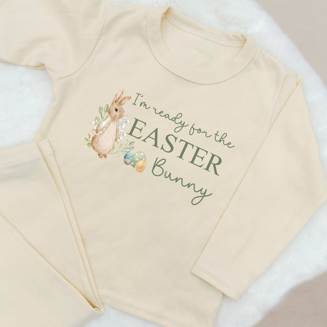 Personalised beige pyjamas that says 'I'm ready for the Easter Bunny'. This design features a rabbit wearing a beige jacket surrounded by easter eggs